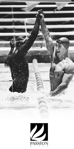 Two men high fiving in a simming pool.